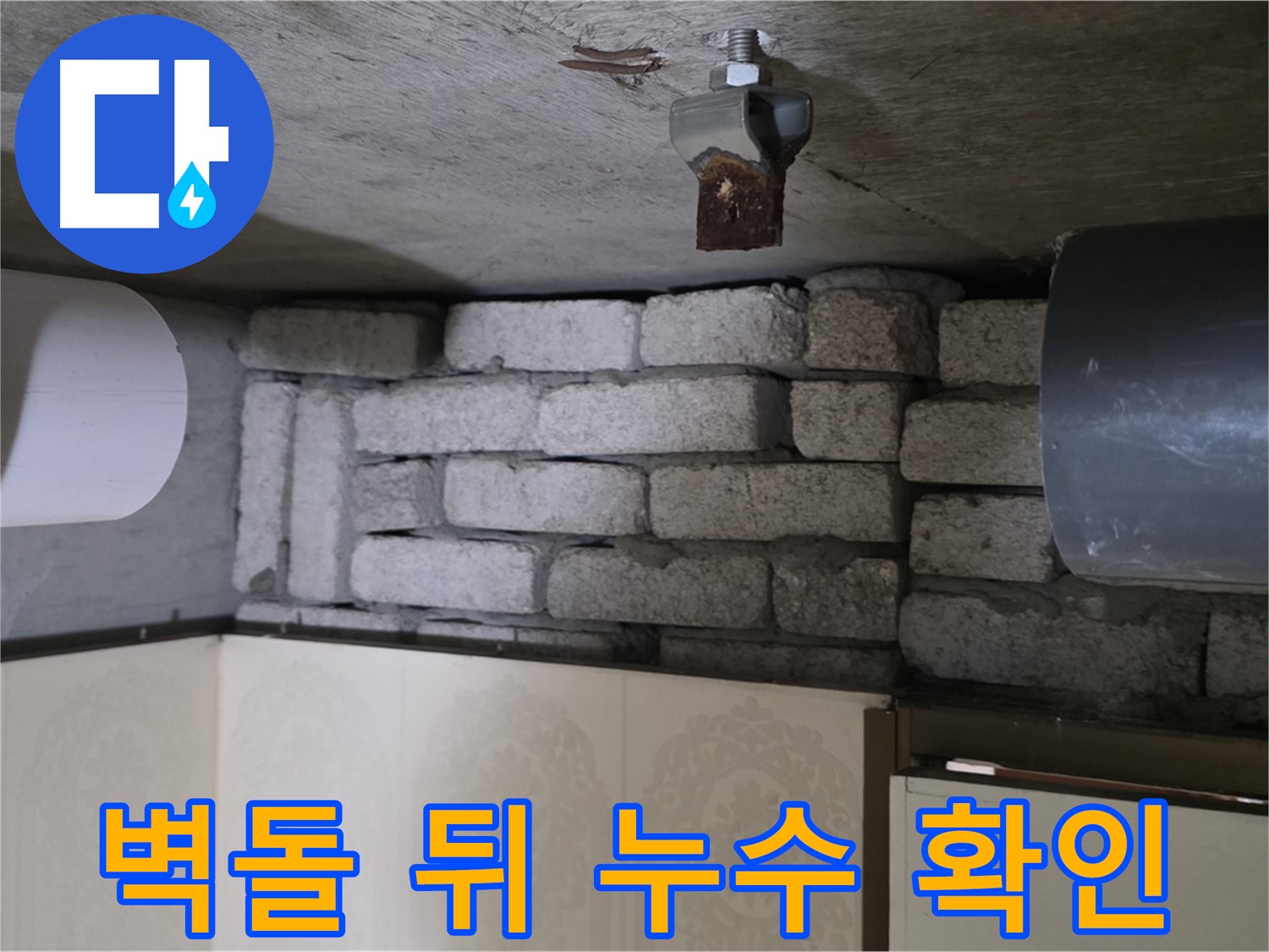 새절역 현대아파트 누수 - 벽돌 뒤 숨겨진 배관의 누수 지점을 정밀하게 확인하는 모습