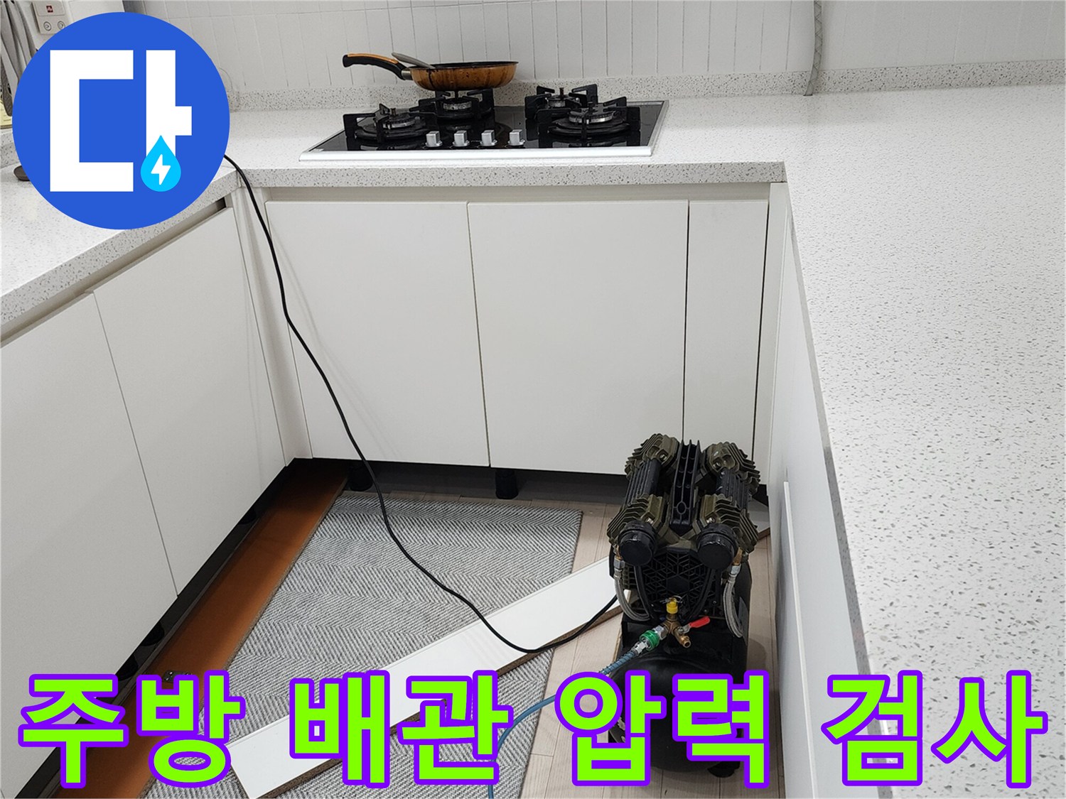 주방 싱크대 아래에서 진행 중인 배관 공압 테스트 장비 모습