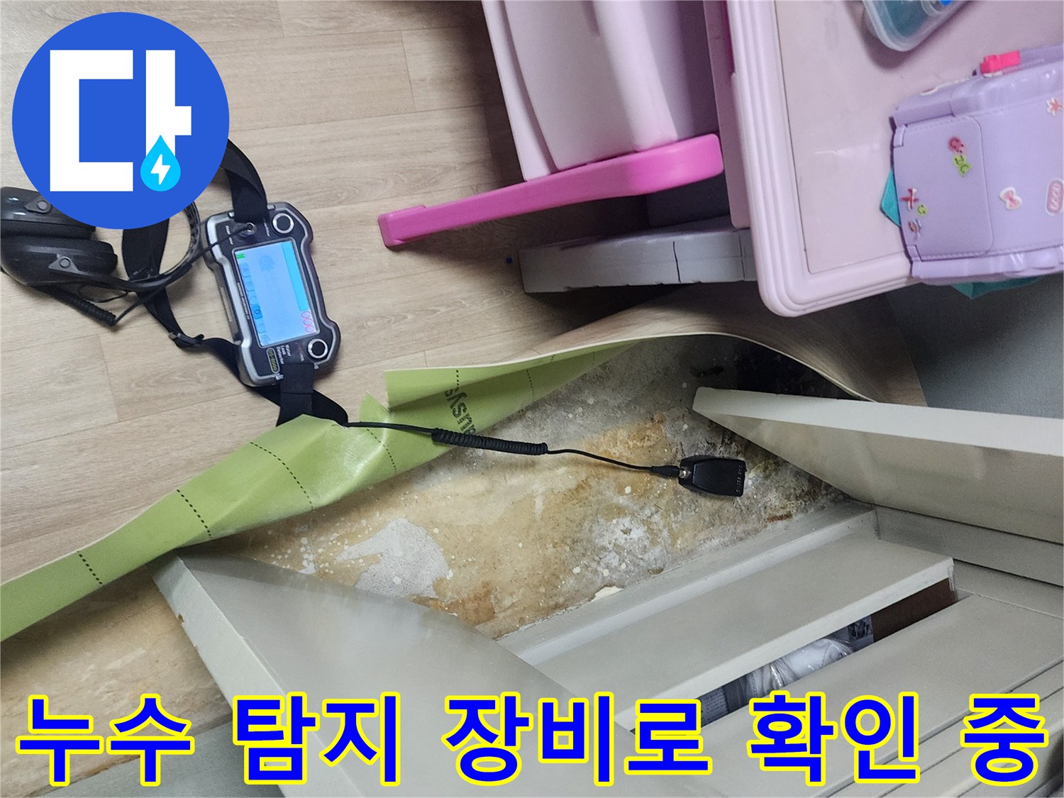 바닥재를 제거한 공간에서 가스 탐지기로 배관의 이상 유무를 점검하는 모습입니다.