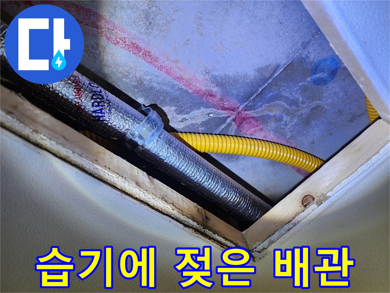 노란색 유연 배관과 은색 보온재 주변의 젖은 벽면