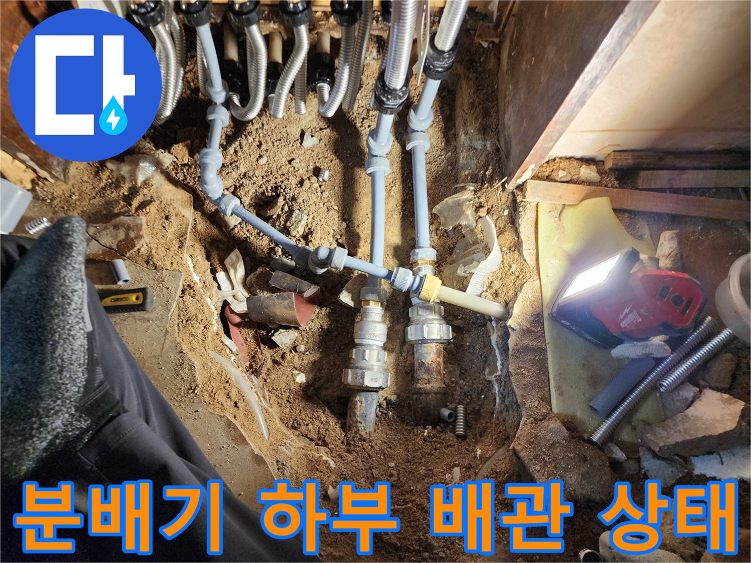 보일러 분배기 하단에 드러난 젖은 흙과 노후된 연결 부위