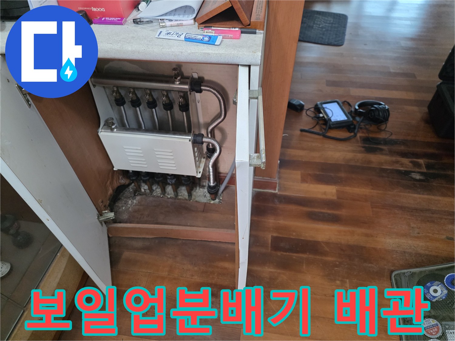 싱크대 하부 분배기 밸브와 연결된 난방 배관의 근접 촬영