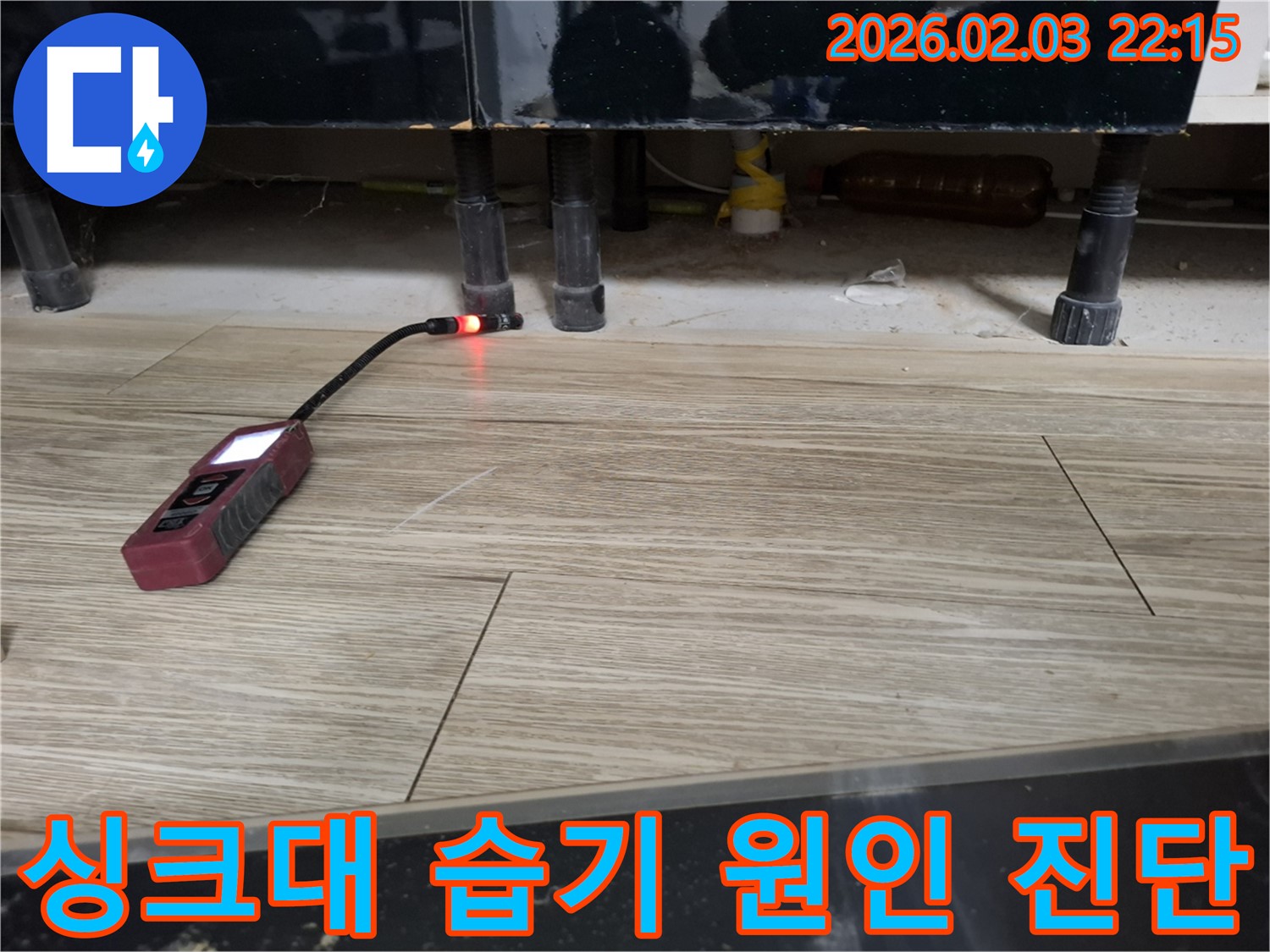 싱크대 하부에서 누수 탐지 장비로 습기 원인을 진단하는 모습 - 곰팡이 냄새의 주범을 찾아라!