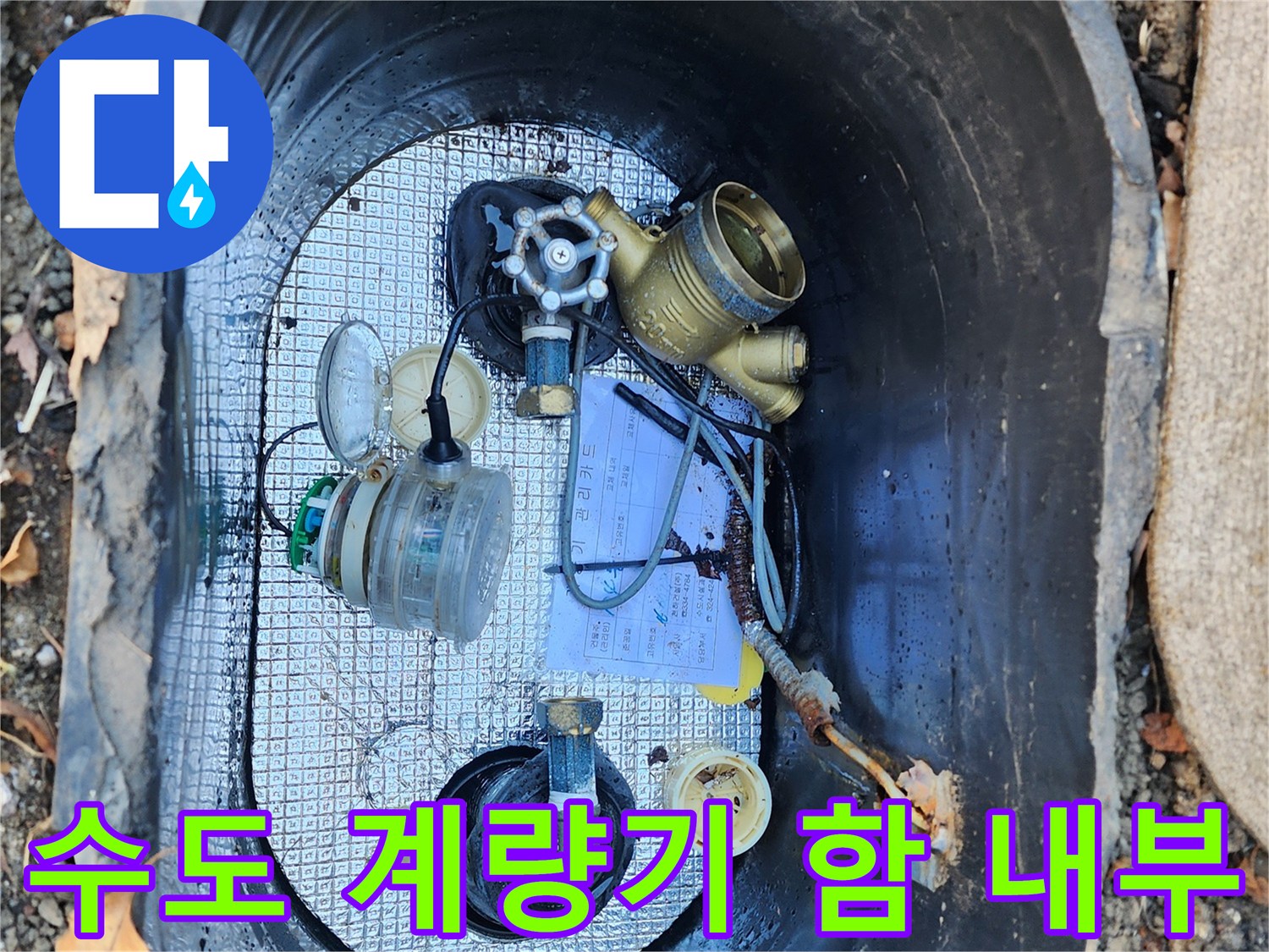수도 계량기함 내부에 보이는 황동색 계량기와 연결 배관들