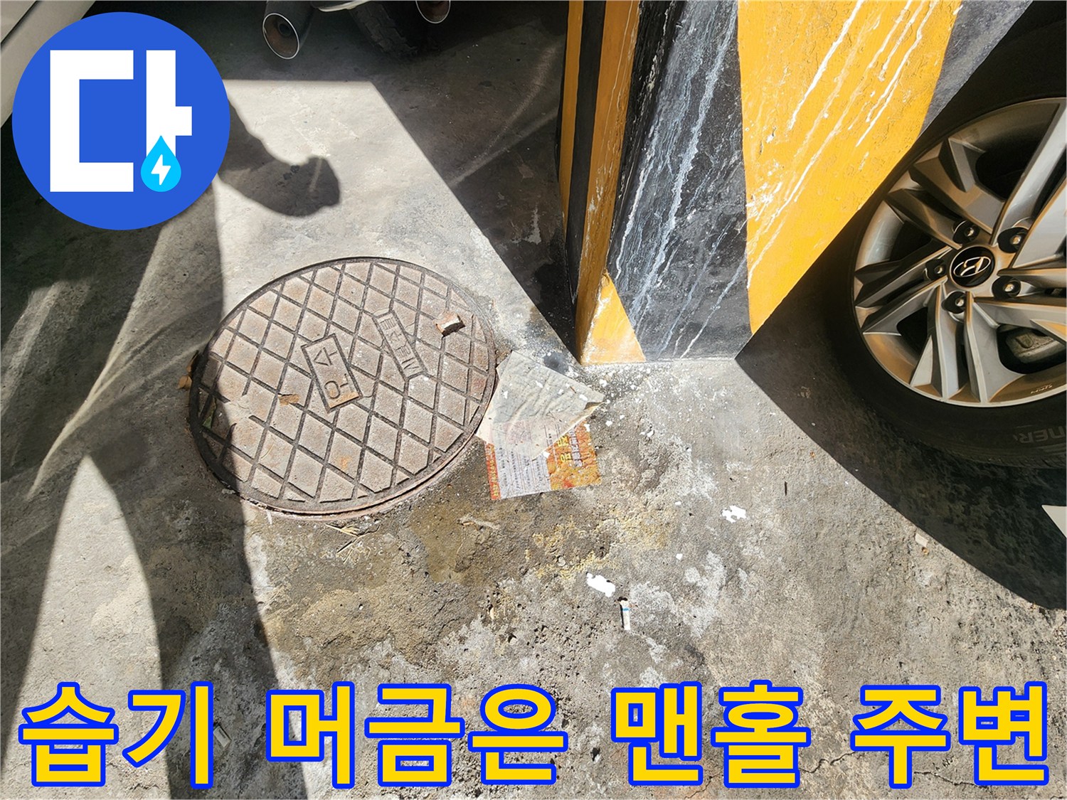 물기가 남아있는 주차장 바층 맨홀 덮개 부근