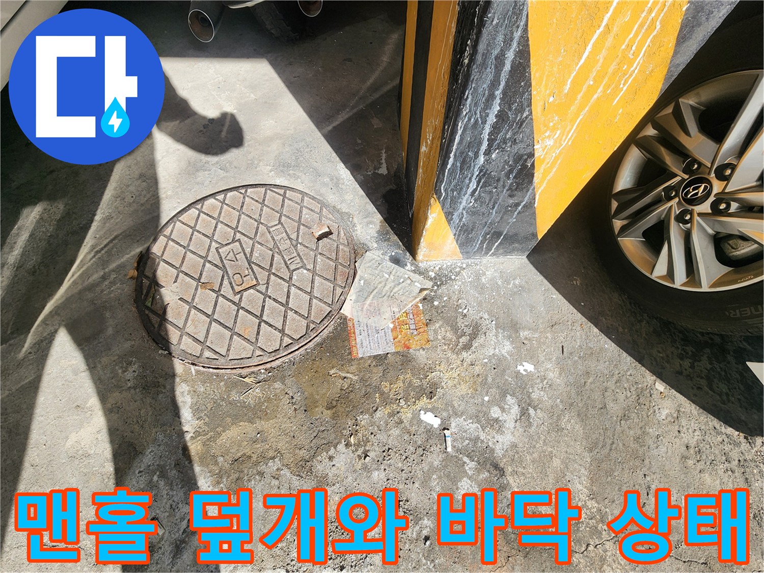 주차장 바닥의 맨홀 뚜껑과 주변 콘크리트 균열 상태