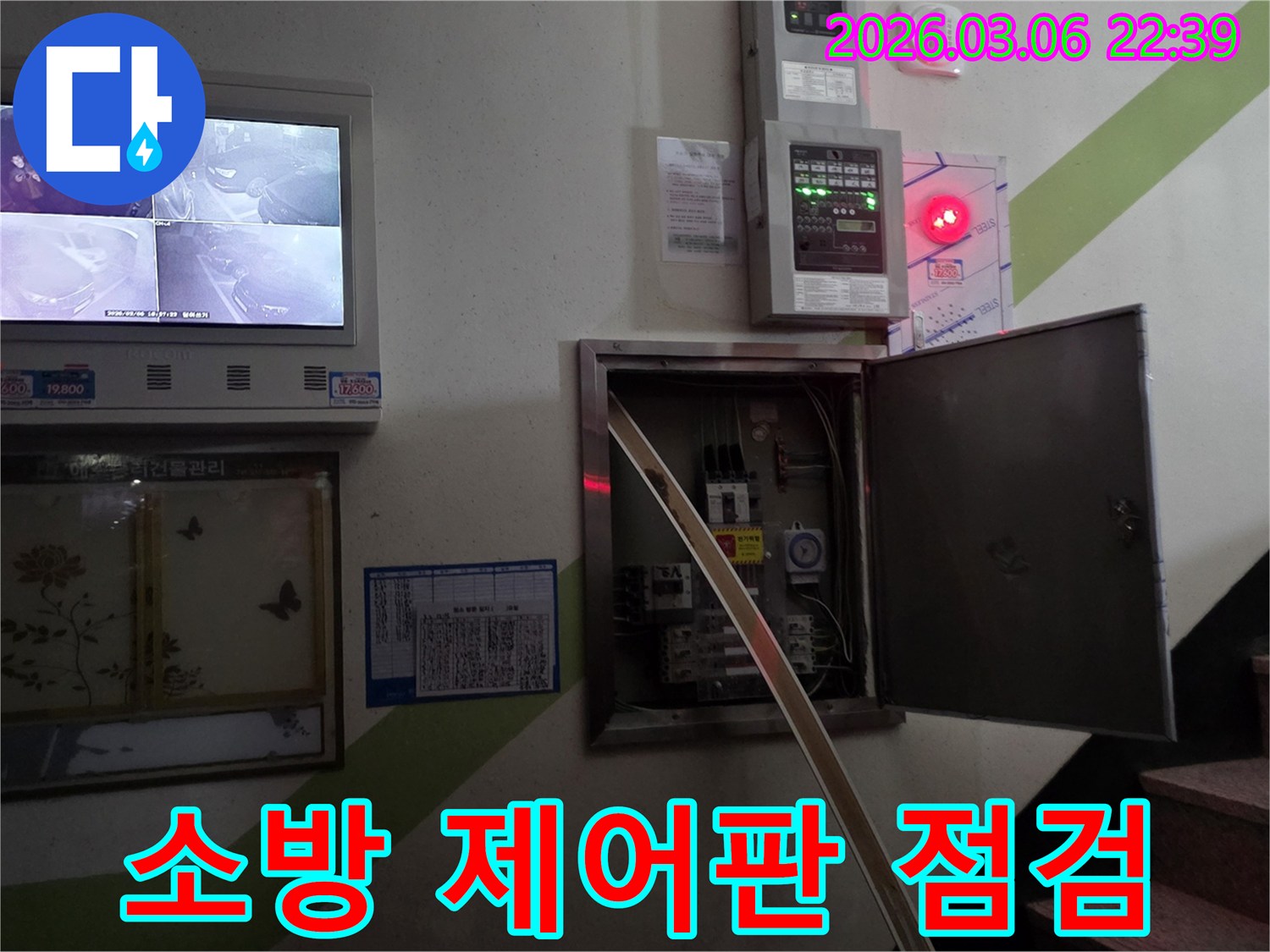 누수 현장에서-소방 설비 제어판의-각종 버튼과 표시등의-작동 상태를 점검하는 장면입니다.