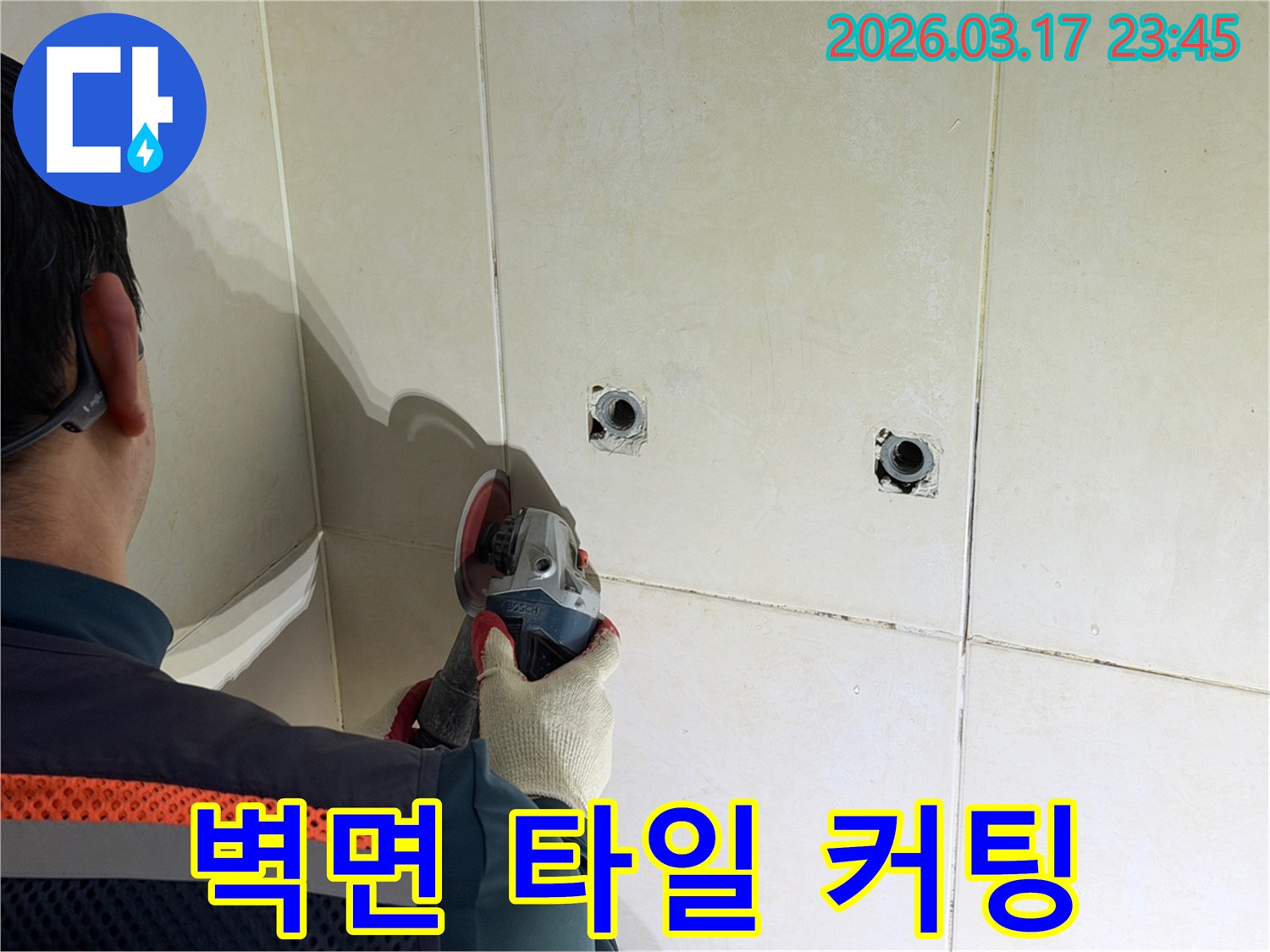 누수된 배관을-노출시키기 위해-전문가가-벽면 타일을-그라인더로-조심스럽게-커팅하고-있습니다