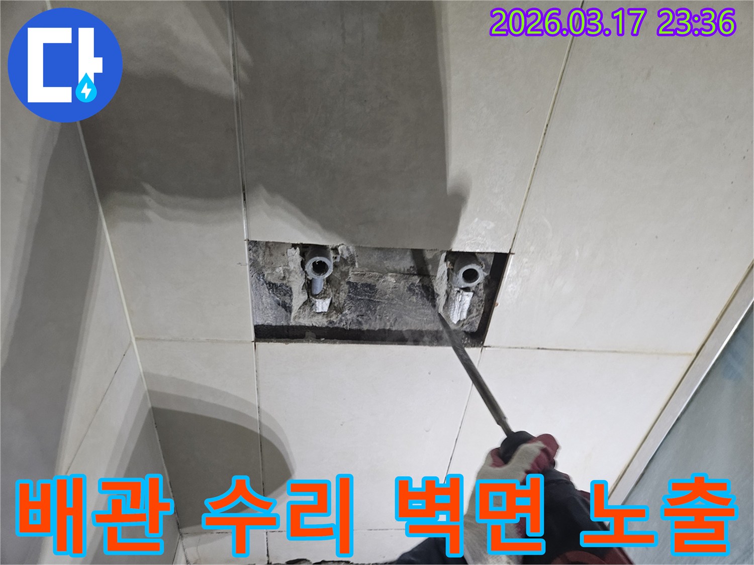 숙련된 기술자가-누수 탐지 후-타일 아래 숨은-배관을 드러내고-수리를 준비하는 작업