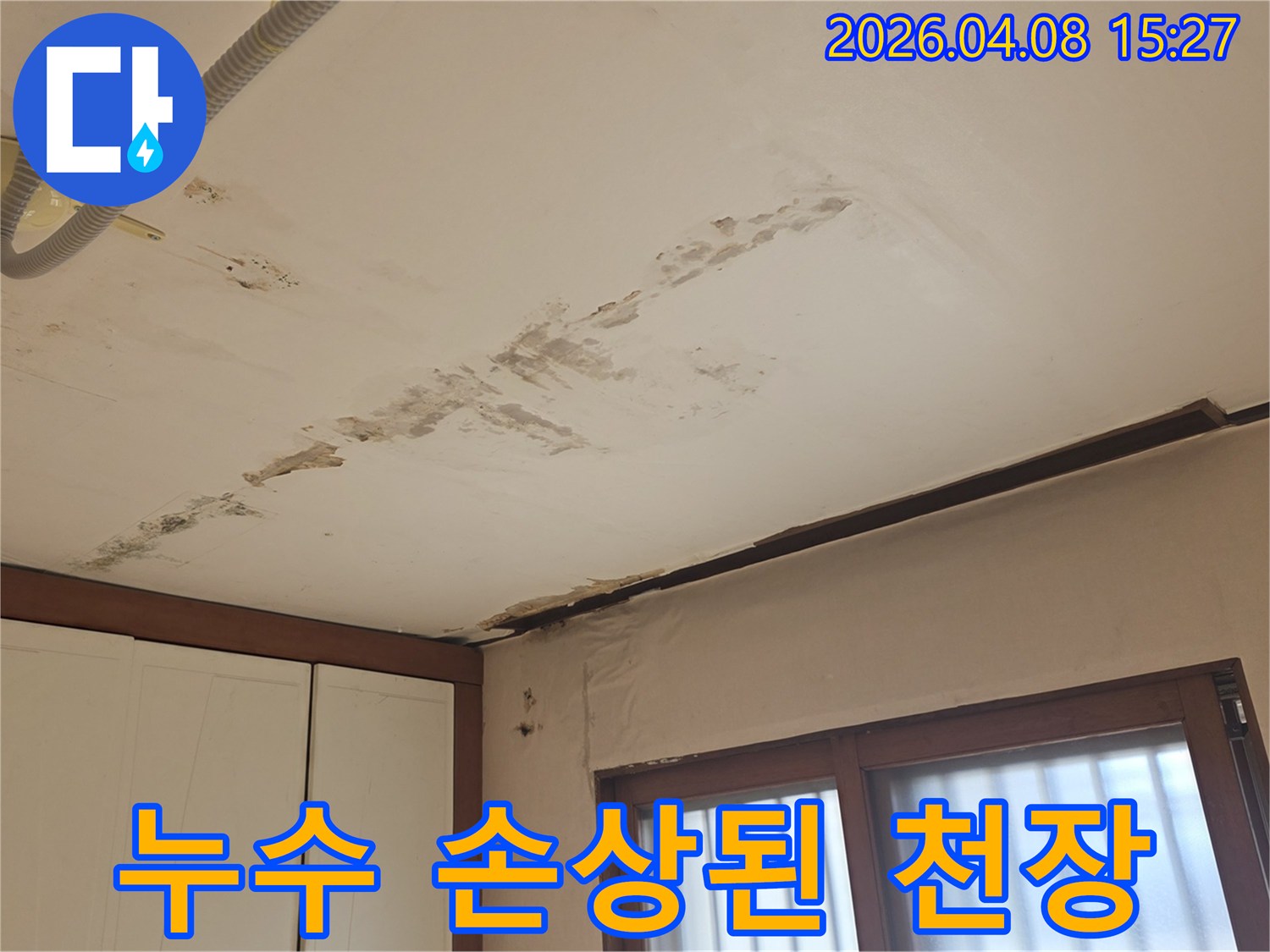 천장과 벽의 경계선에서-물이 스며들어 벽지가 젖고-페인트가 벗겨진 누수-피해 현장의 모습입니다
