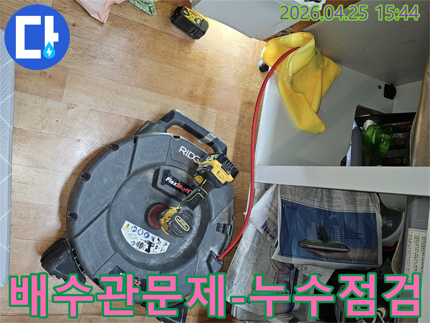 주방 배수관에서 발생할 수 있는-누수 문제를 사전에 점검하고-배관 내부의 상태를 확인하기 위해-전문 장비를 사용하는 모습