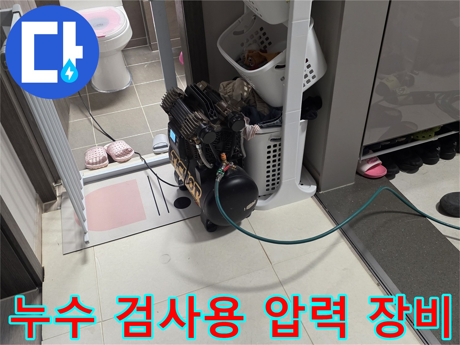 싱크대 하부장 근처에 설치된 공압 테스트용 컴프레셔와 호스