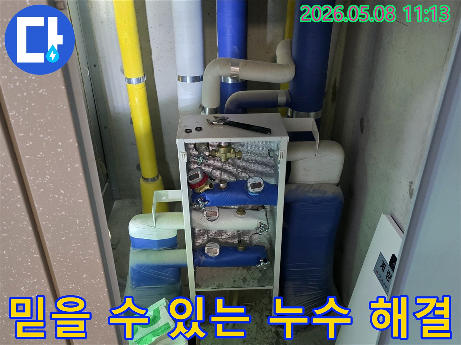 이 이미지는 건물의 유틸리티 공간에 설치된-다양한 배관과 계량기-그리고 작업 도구를 보여주며-이는 믿을 수 있는 누수업체의-전문적인 배관 누수 해결 작업이-진행될 준비를 나타냅니다