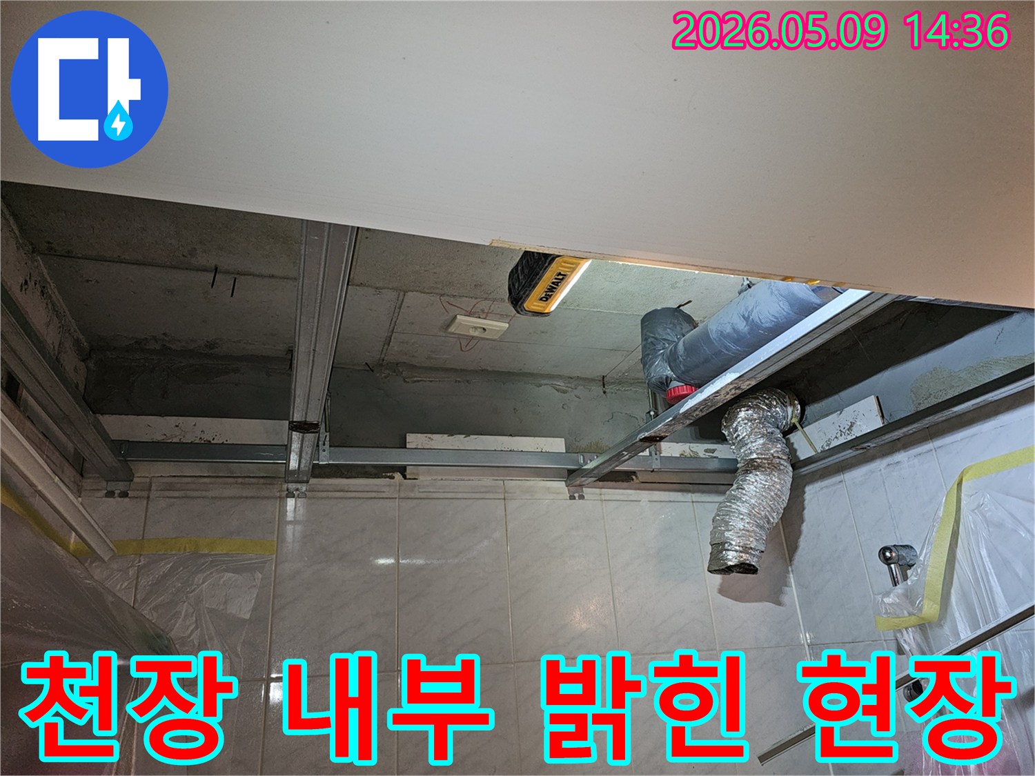 엔지니어가-휴대용 조명을 사용하여-어두운 천장 내부를-환하게 밝히고-누수 지점을-찾아내는-작업 현장입니다