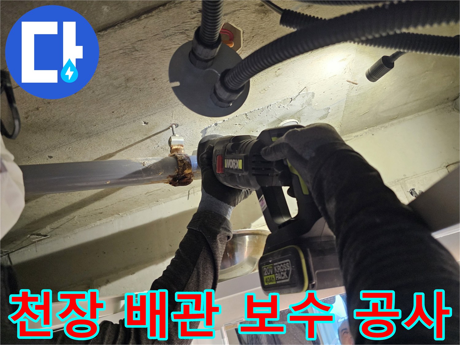 전동 드릴로-배관 고정 클램프를 조이는 작업 장면