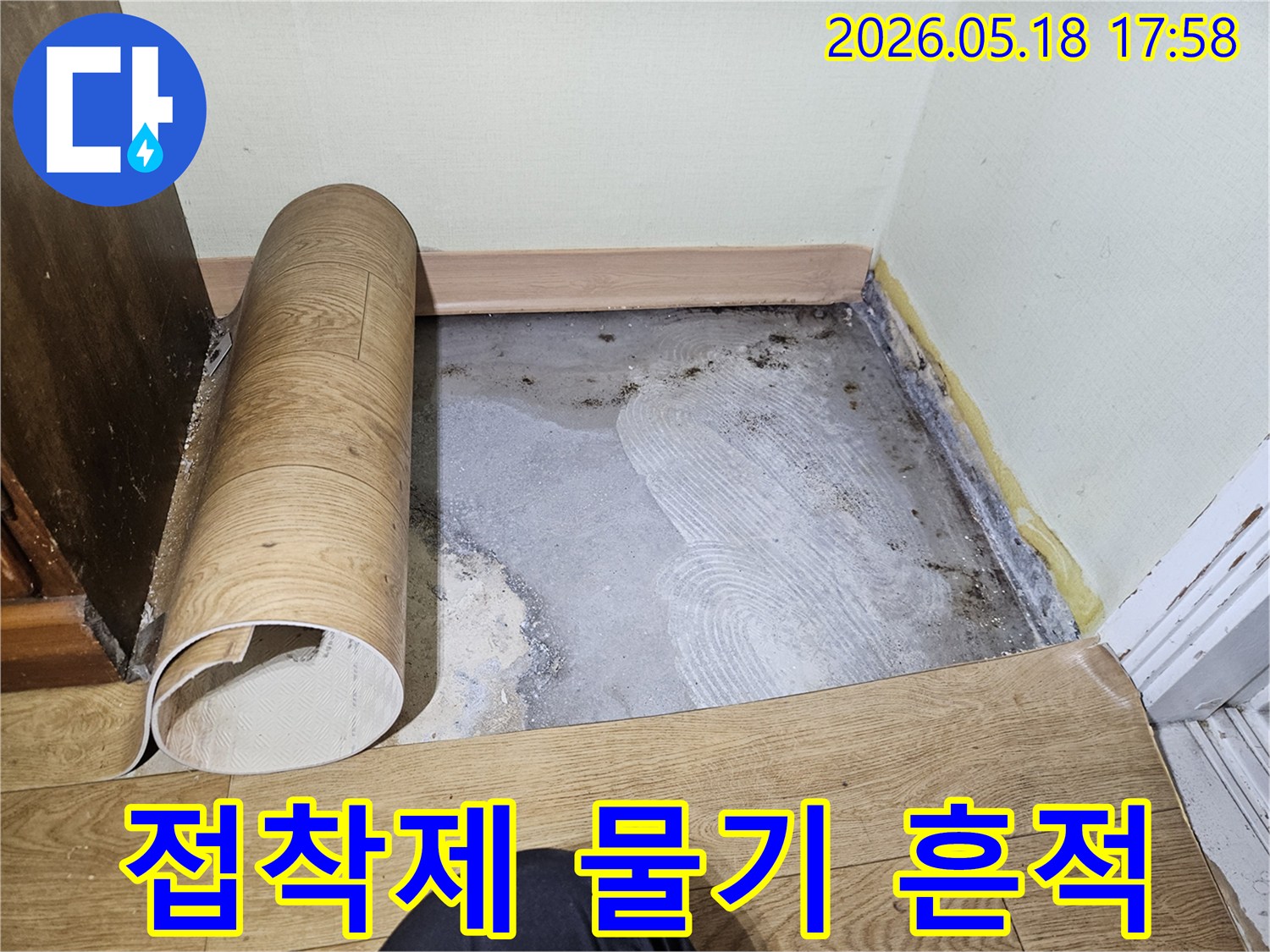 바닥-마감재를-제거한-후-누수로-인해-젖어있고-오래된-접착제-흔적이-남아있는-콘크리트-바닥