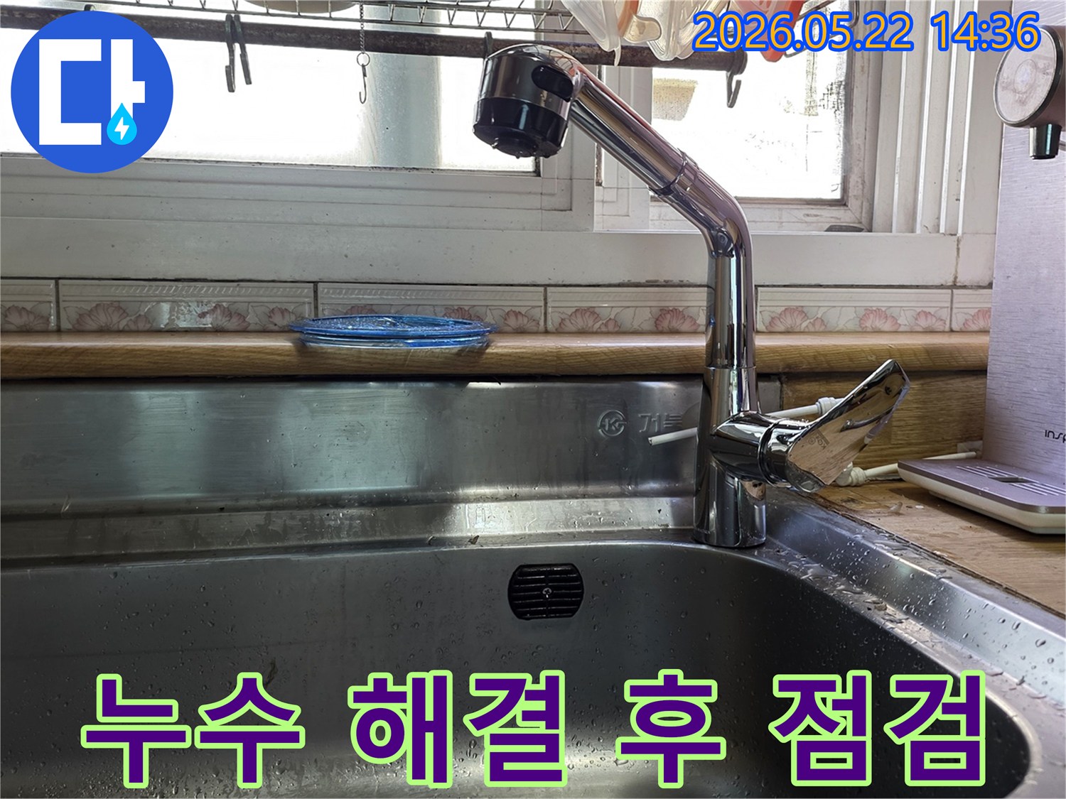 이 이미지는 누수 수리 후 깨끗해진 주방 싱크대와 수도꼭지를 보여주며-물이 새지 않는지 최종 점검하는 모습입니다