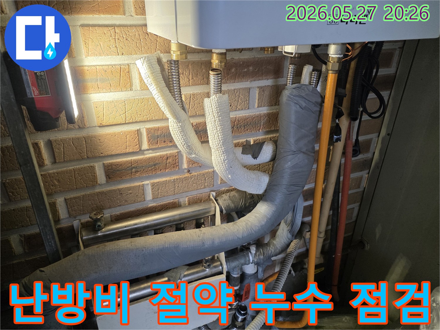 보일러 하단의 단열된 배관들이-벽돌 벽에 설치된 모습으로-난방비 절약을 위한-누수 점검이 필요한 현장입니다