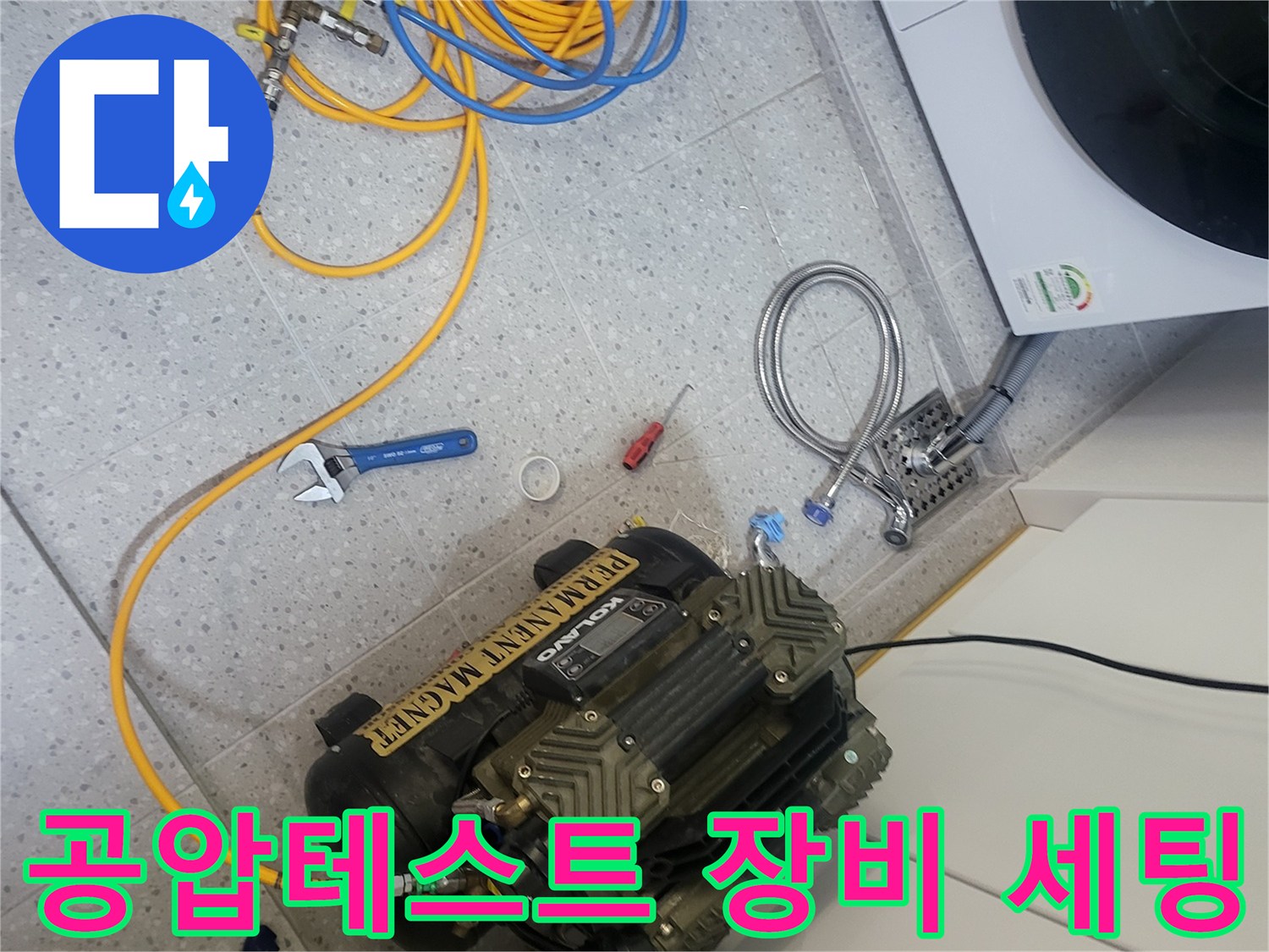 세탁실 바닥에 설치된 공압 테스트용 에어 컴프레셔와 연결 호스들