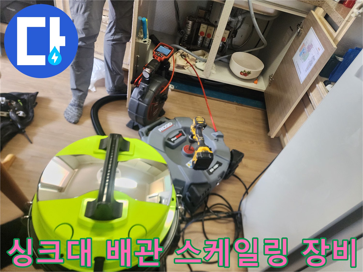 싱크대 하부장 아래에 배치된 배관 스케일링 및 석션 장비 모습