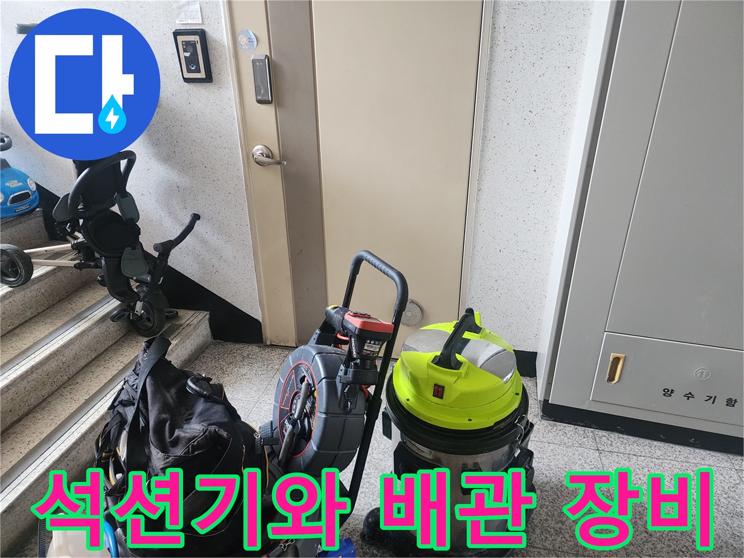 복도 바닥에 놓여 있는 전문적인 하수구 청소용 석션기 및 도구