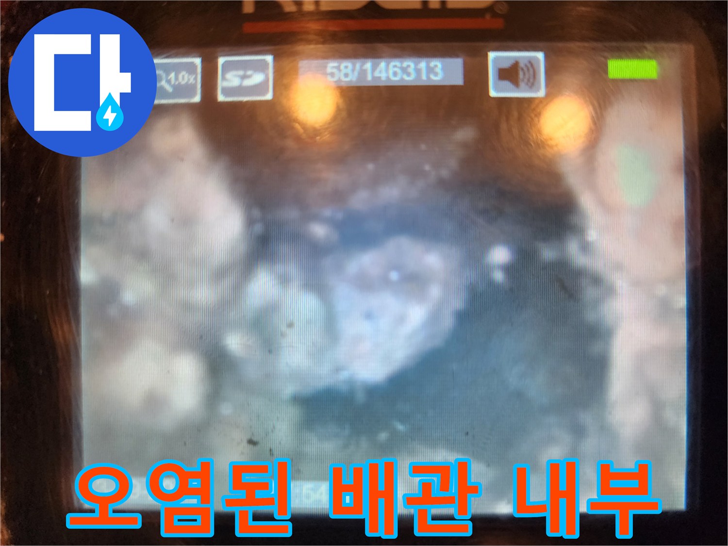 배관 벽면에 달라붙은 이물질과 요석의 근접 촬영 화면입니다.