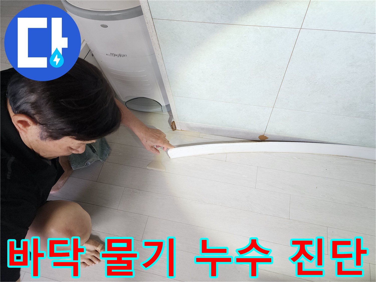 누수-엔지니어가-바닥-마감재-틈새에서-발견된-물기를-통해-누수-진단을-진행하는-모습