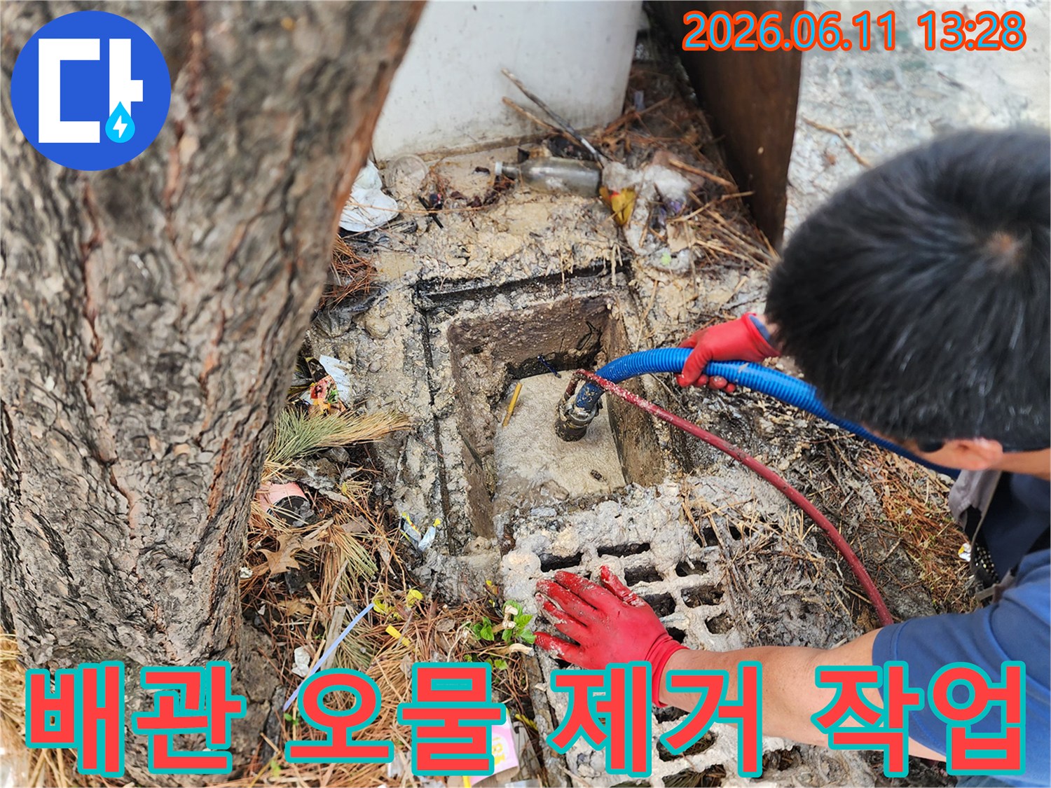 파란색 흡입 호스를 사용하여-집수정 내 배관 찌꺼기를 제거하는 현장입니다.