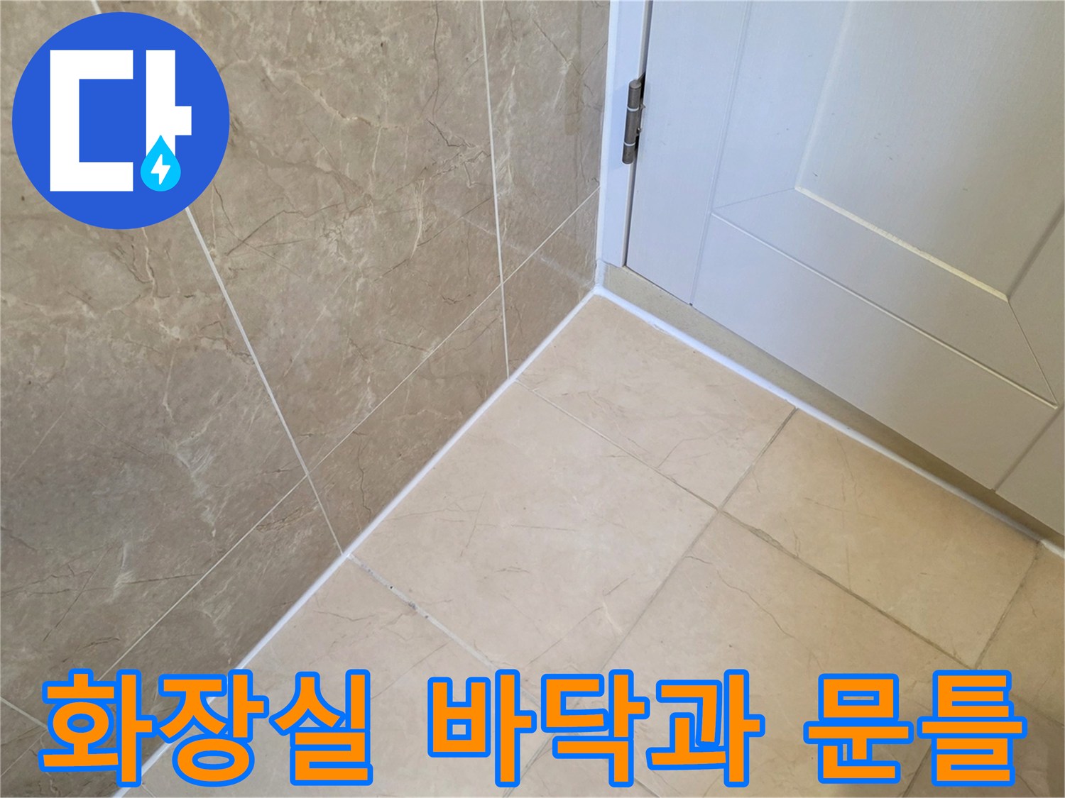 정돈된 상태의 화장실 바닥 타일과 깨끗한 문틀 하단부