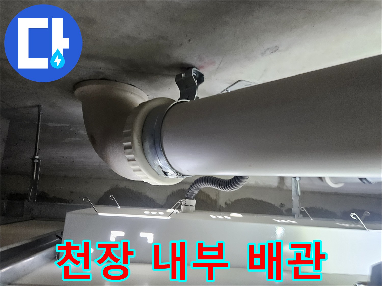 천장에 설치된 굵은 하수 배관과 연결부 상세 사진