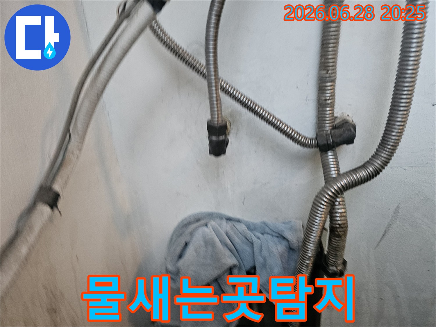 물-새는-곳을-찾기-위해-배관을-면밀히-살피는-모습