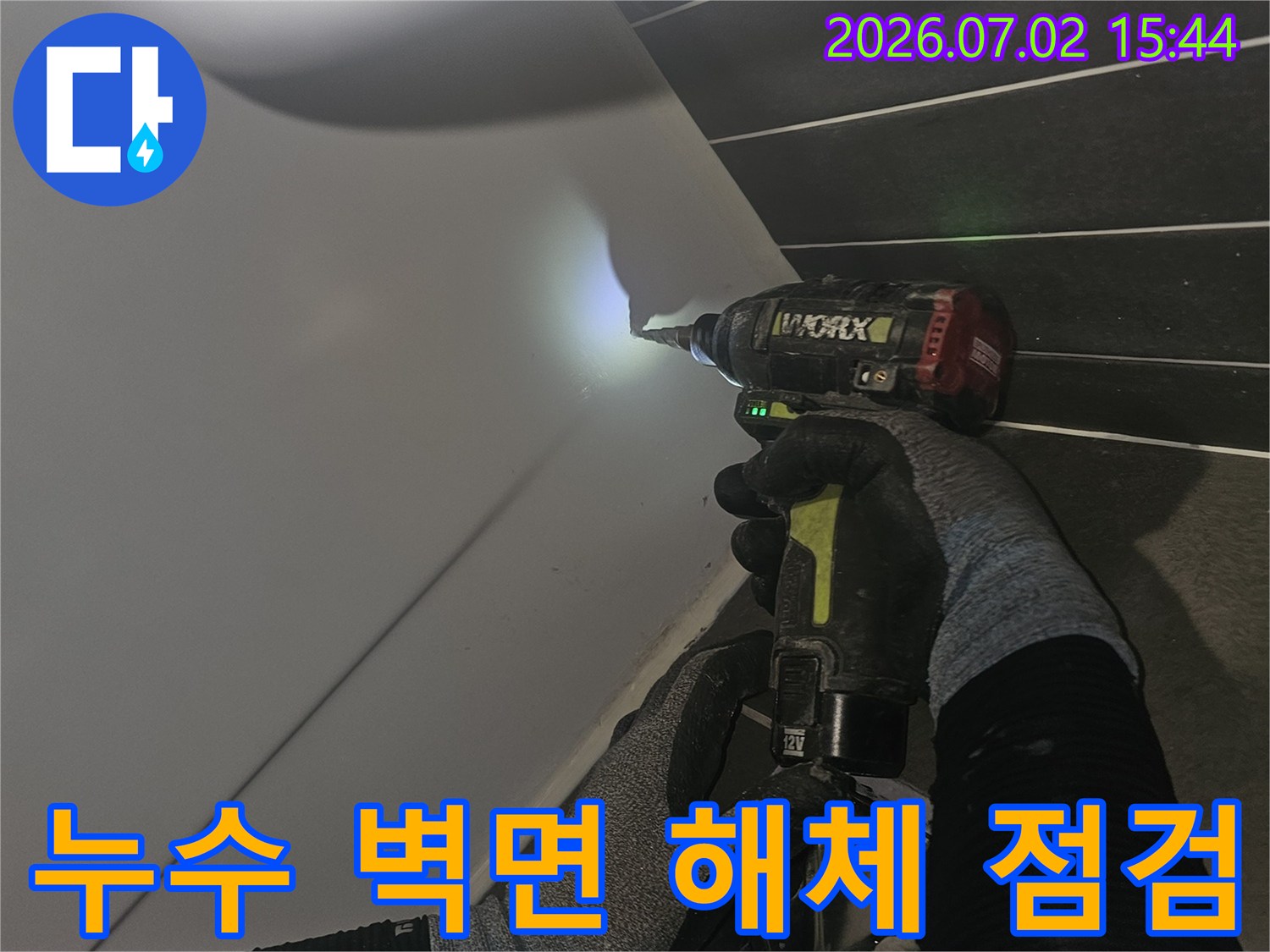 누수-공사-현장에서-타일을-제거하는-작업자가-전동-드릴을-사용하고-있습니다
