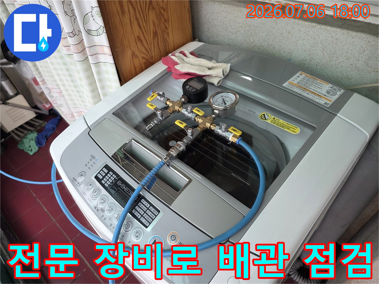 세탁실 내부에 설치된 파이프에 측정용 호스와 게이지를 연결한 모습