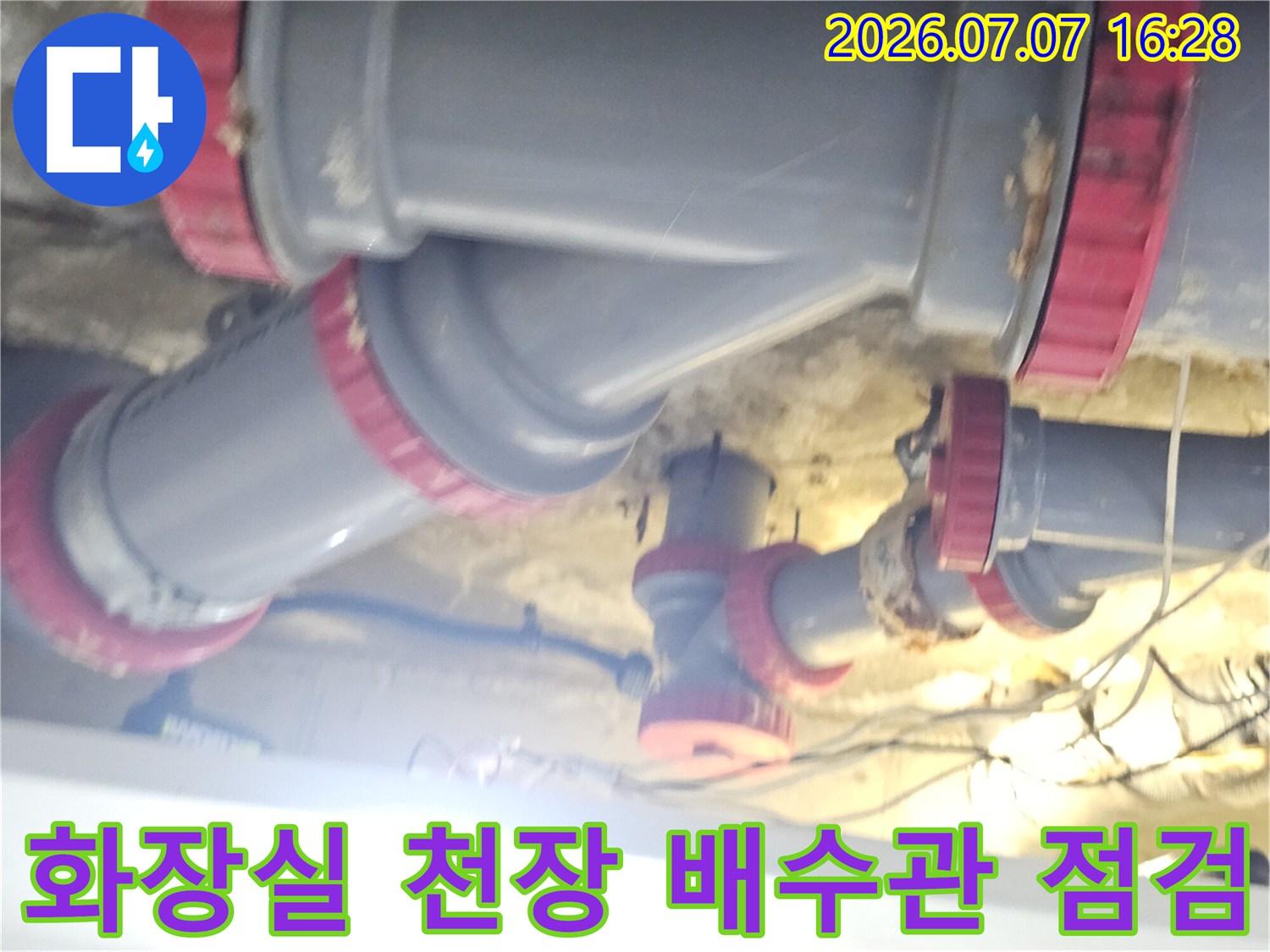 화장실 천장 내부의 붉은색 테두리가 있는 회색 배수관 연결 부위