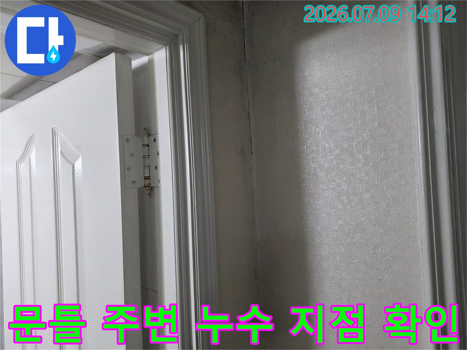 내부 문틀과 벽면의 접합부를 조사하며 누수 경로를 추적하는 장면