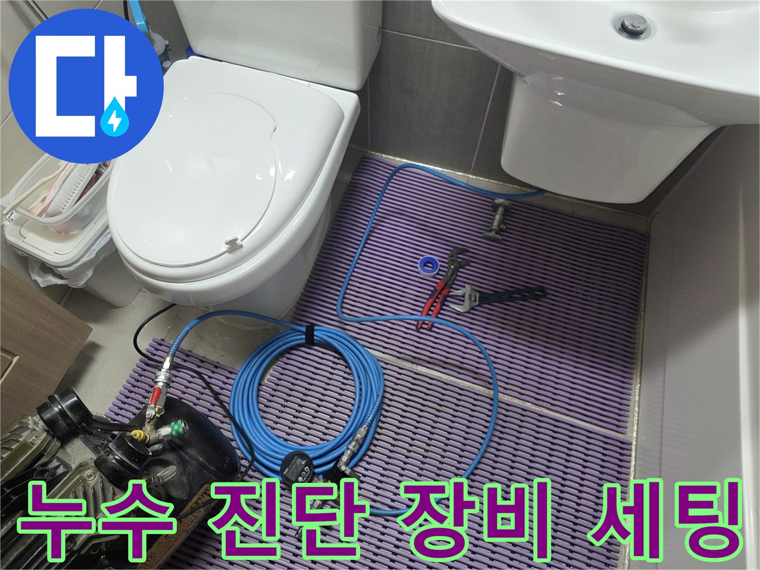 변기와 세면대 사이 바닥에-배치된 누수 탐지 장비