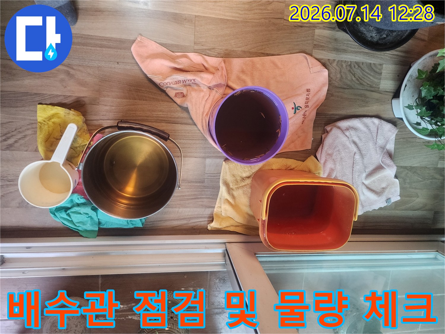 베란다 바닥에 배치된 용기들과 누수 점검용 도구들-체계적인 진단 과정