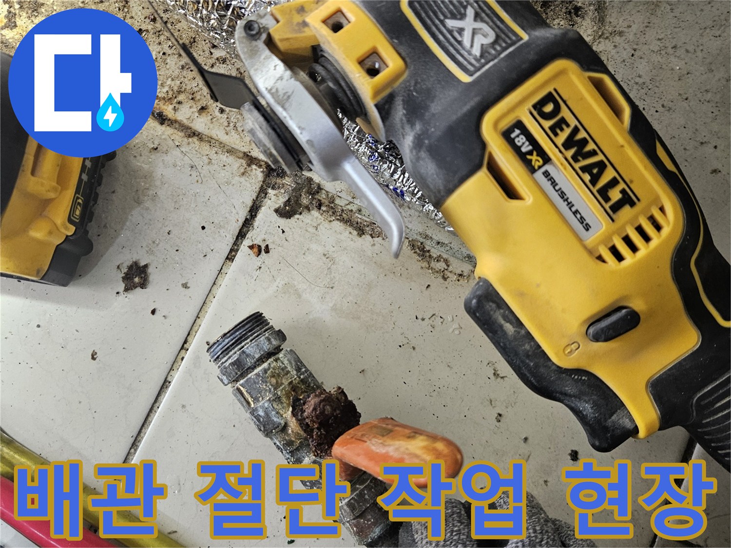 전동 그라인더를 사용하여 부식된 배관을 절단하는 모습