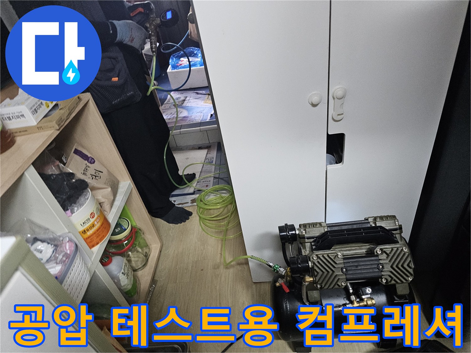 배관 압력을 가하기 위해 싱크대 옆에 설치된 에어 컴프레셔 장비
