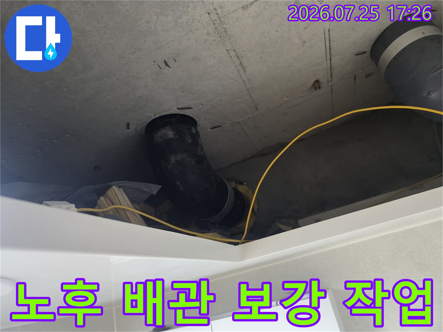 천장 내부에 노출된 검은색 배관과 보호용 보온재를 점검하는 모습