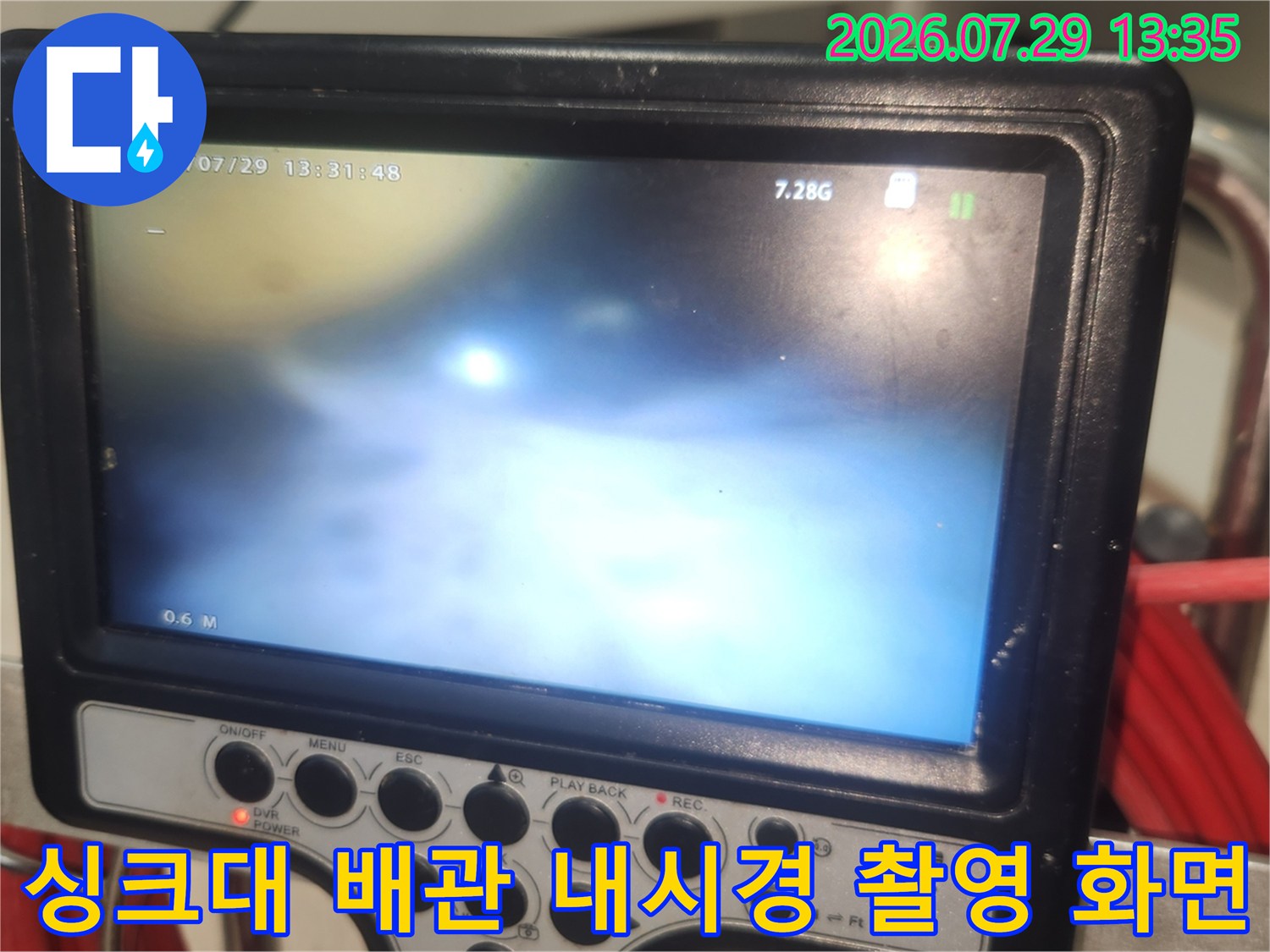 모니터를 통해 싱크대 아래 배수구 내부 상태를 세밀하게 점검하는 과정