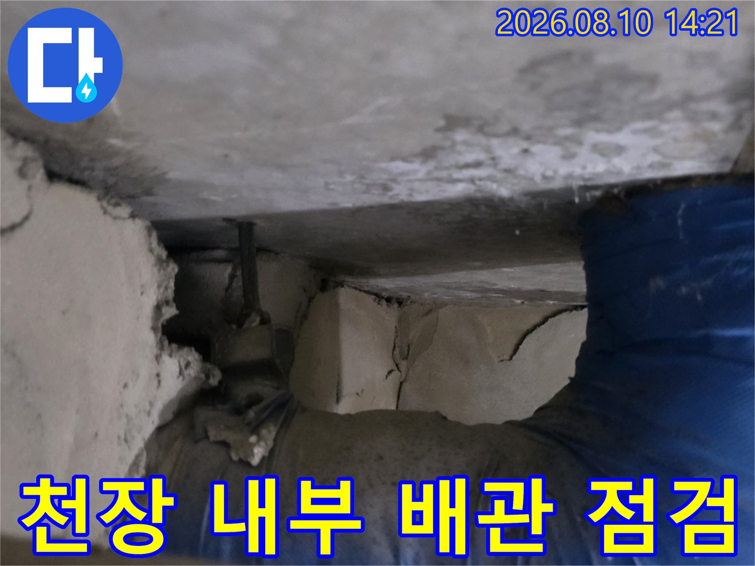 갈라진 천장 틈새와 파란색으로 감싸진 배관의 모습