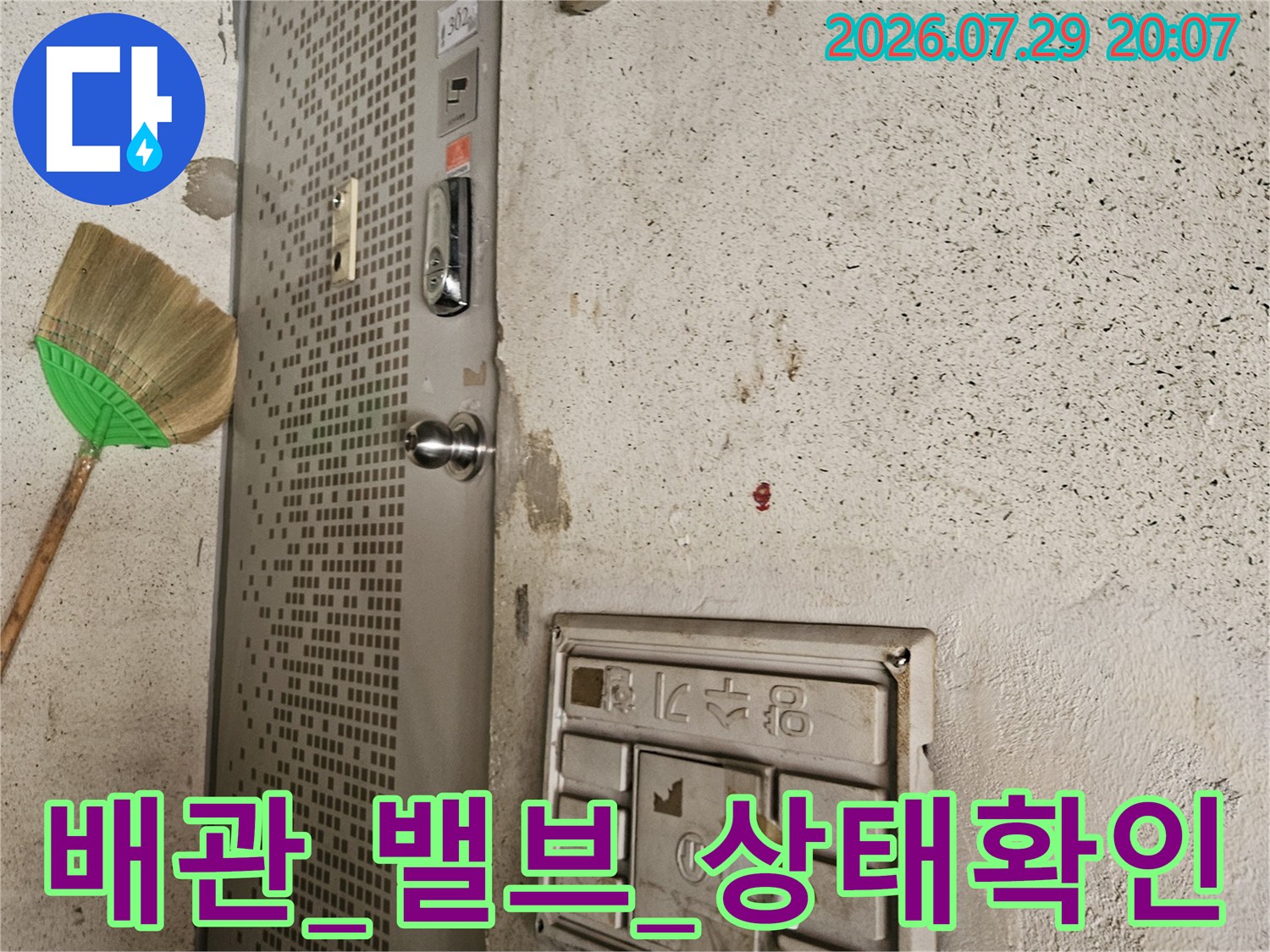 벽에 노출된 온수와 냉수 배관의 연결부 상태를 점검하는 과정