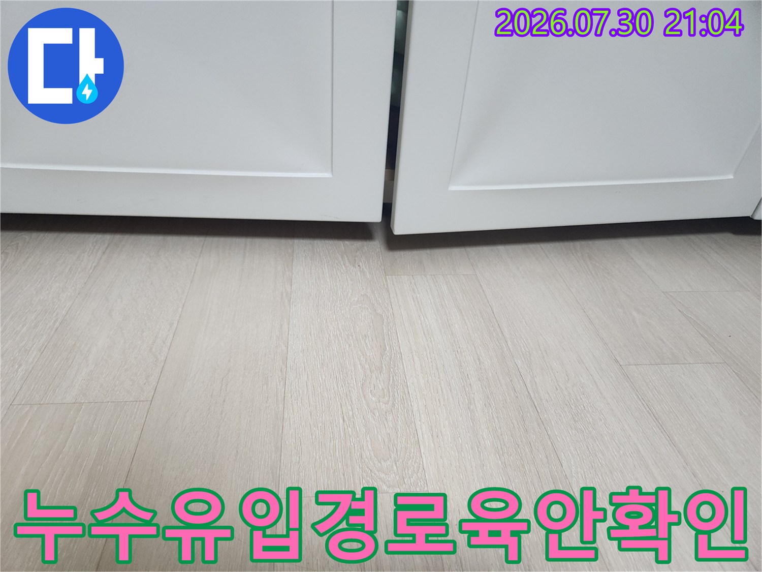 가구 하부 공간의 바닥 상태를 점검하며 누수 경로 파악