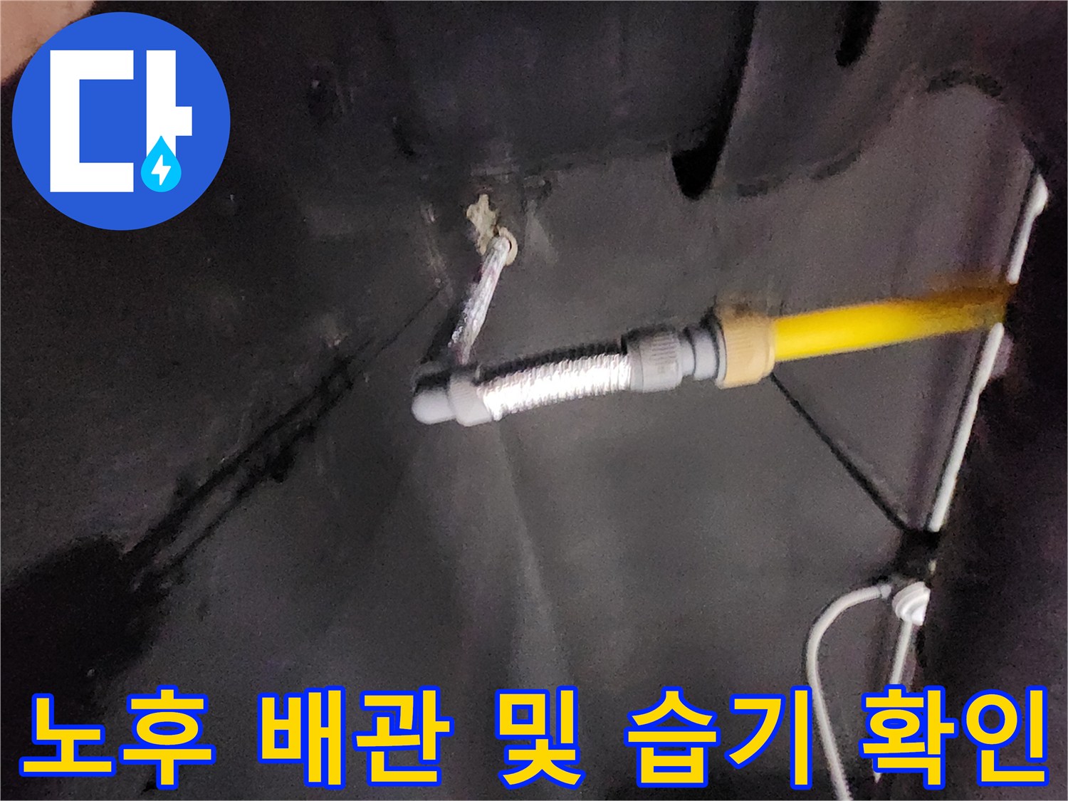 싱크대 하부 배관 연결 부위의 물샘 흔적과 노란색 호스