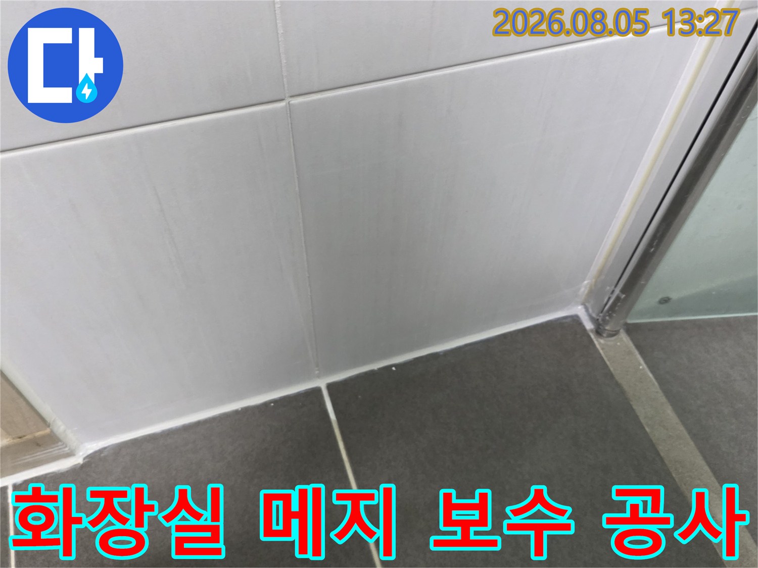 노후된 화장실 타일 줄눈을 점검하고 방수 보강을 위한 기초 작업을 수행하는 장면
