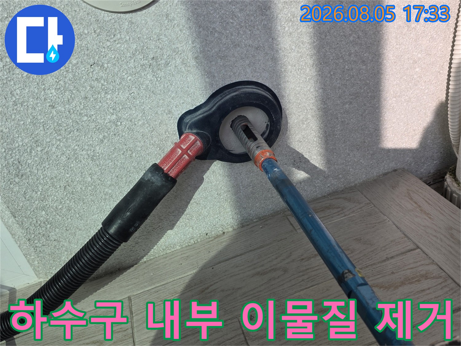 전용 기기를 이용해 세탁실 배출구의 막힌 부분을 파쇄하여 뚫어주는 장면
