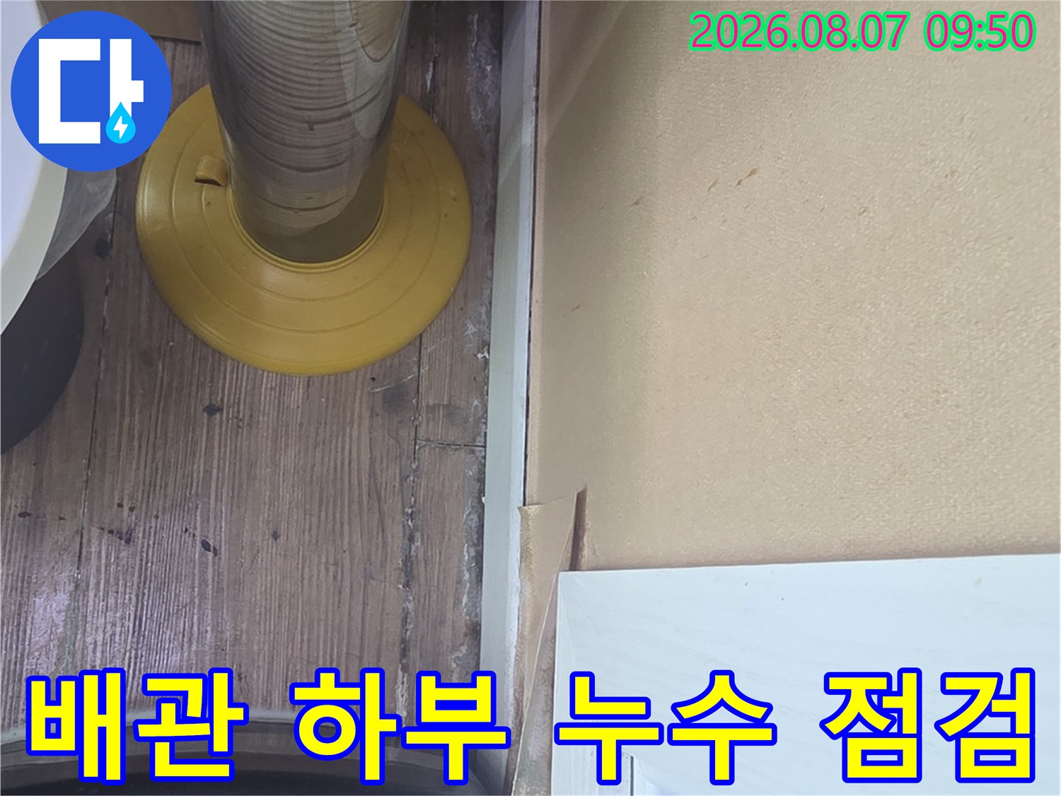 배관 연결 부위의 틈새와 바닥 마감재 상태를 확인하는 작업입니다.