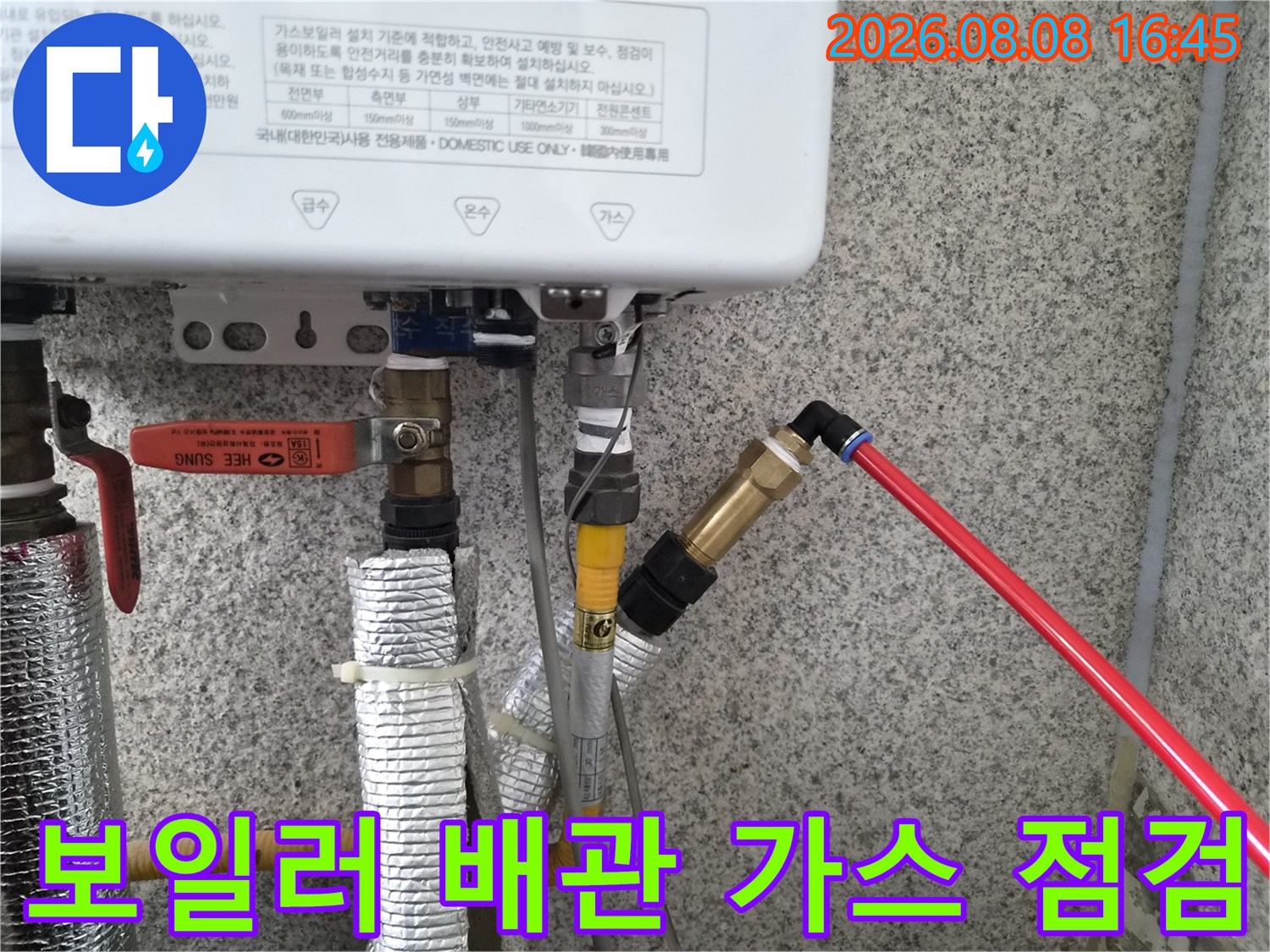 보일러 하단 배관에 가스 탐지기를 연결하여 누수 지점을 찾는 모습입니다.
