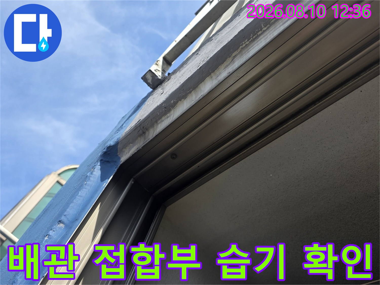 배관과 창틀 사이의 젖은 흔적을 촬영한 사진입니다.